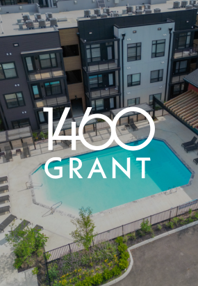 Aerial view of Columbus apartments with a swimming pool in the courtyard; text overlay reads 1460 Grant.