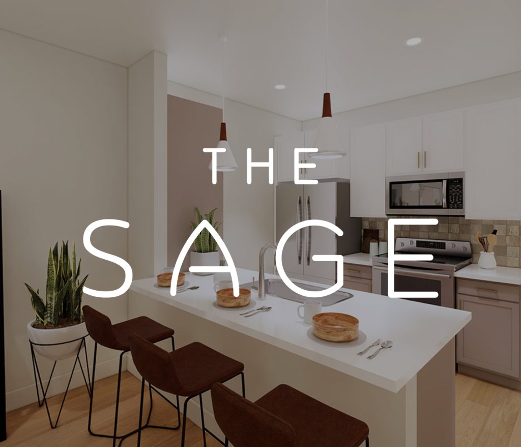 The Sage features a modern kitchen with an island, three brown stools, hanging lamps, and a plant. Experience stylish Columbus apartments where design meets comfort.