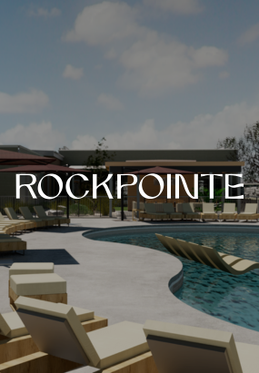Thrive Companies, Outdoor pool area with lounge chairs and submerged seating under a partly cloudy sky at Tillmore at Quarry Trails; ROCKPOINTE text is centered over the image. Apartments in Columbus Ohio