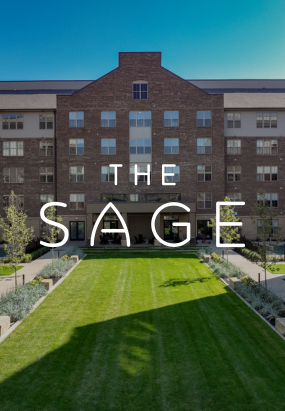 A five-story brick apartment building with a central green lawn in front; the words The Sage at Jeffrey Park are overlaid on the image.