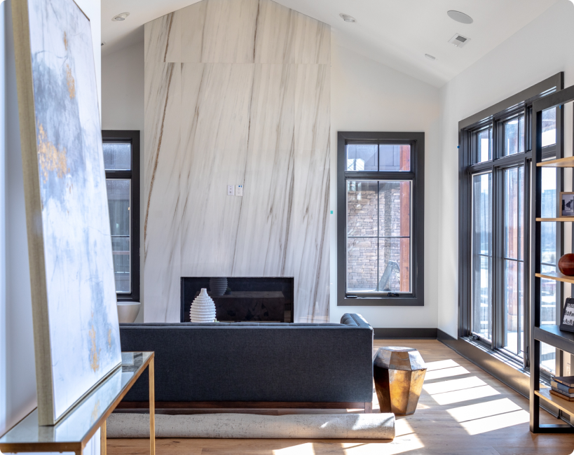 A fireplace and couch in midday at a Quarry Trails home