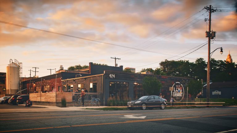 Land-Grant Brewing Co. in Franklinton at sunset with the LeVeque Tower in the background