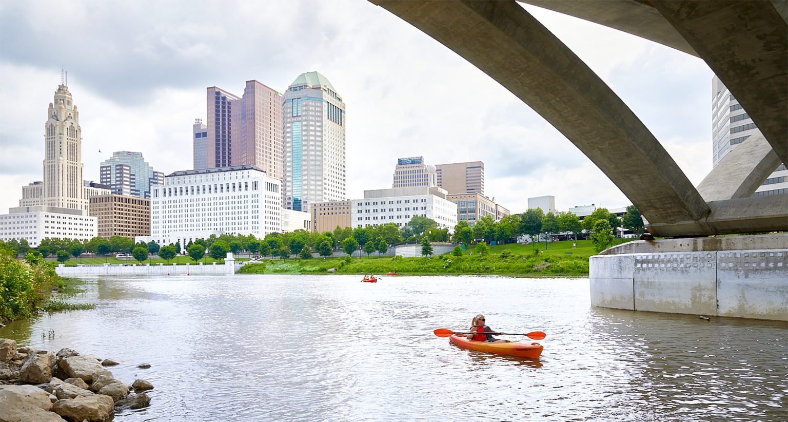 Kayaker on the Scioto River with the Downtown Columbus skyline