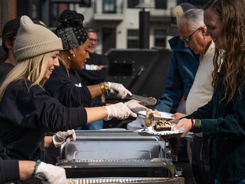 Thrive companies team serving lunch for the community