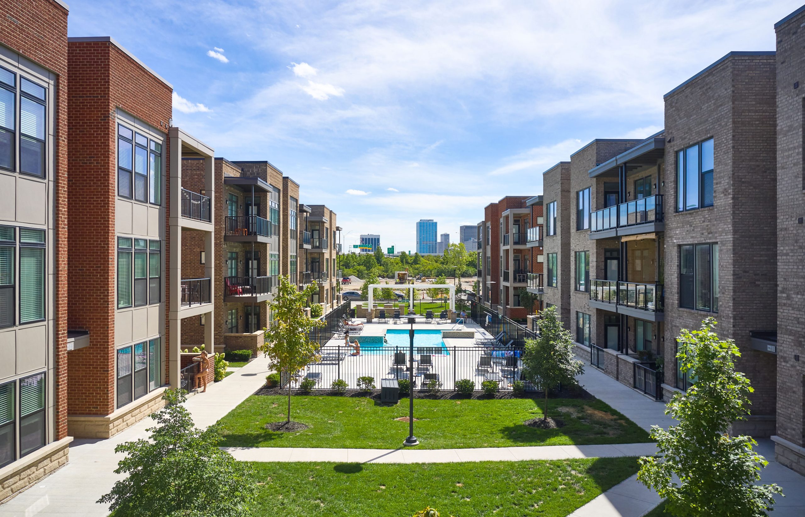 Modern apartment complex with pool by Thrive Companies