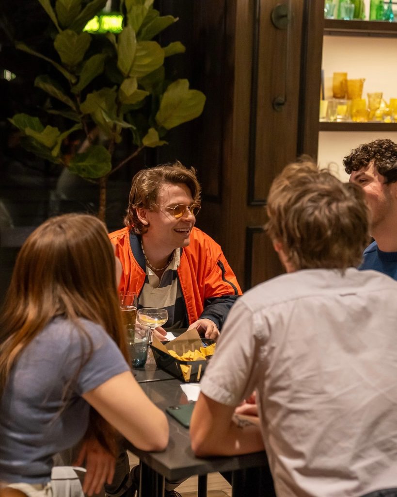 Young group of people enjoying cocktails at Bada Booze