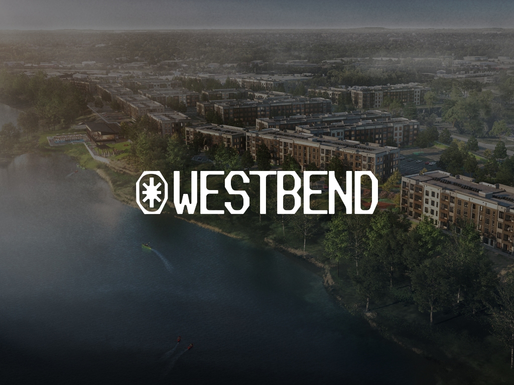 Thrive Companies, Aerial view of a waterfront urban development with apartment buildings, trees, and a river. The word WESTBEND is prominently displayed over the image. Apartments in Columbus Ohio
