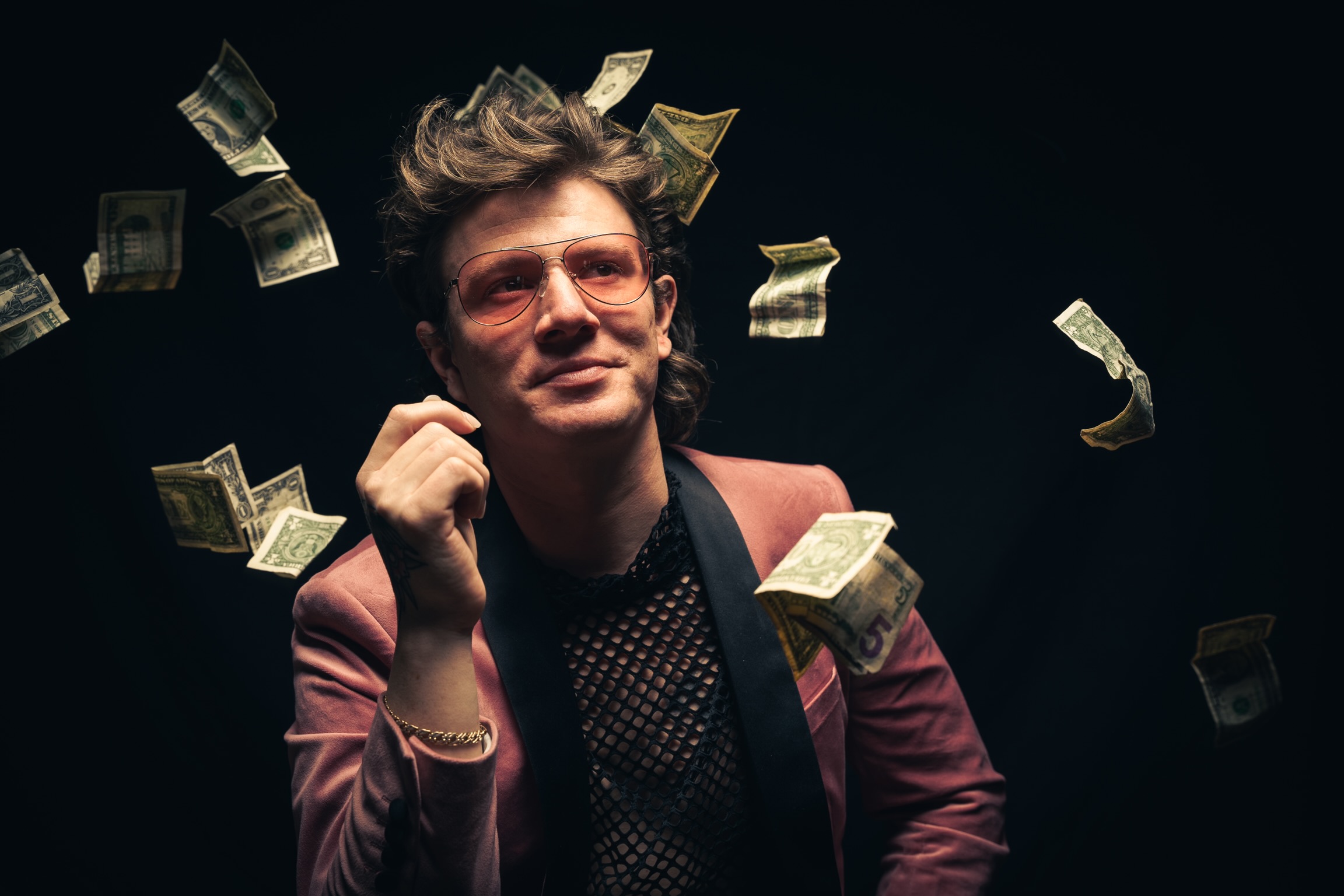 Thrive Companies, A man in sunglasses and a velvet jacket is surrounded by floating dollar bills against a dark background. Apartments in Columbus Ohio