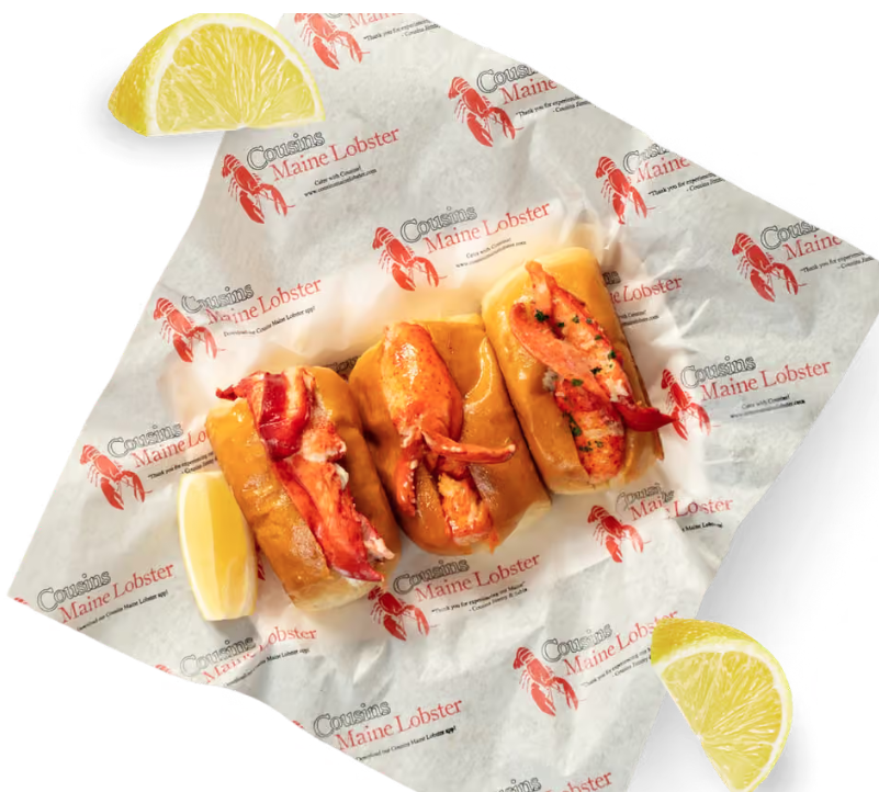 Thrive Companies, Three lobster rolls served on branded paper with lemon wedges. Apartments in Columbus Ohio