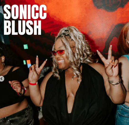 Thrive Companies, A woman wearing red-tinted sunglasses smiles and holds up peace signs with both hands in a nightclub setting. Text overlay reads SONICC BLUSH. Apartments in Columbus Ohio