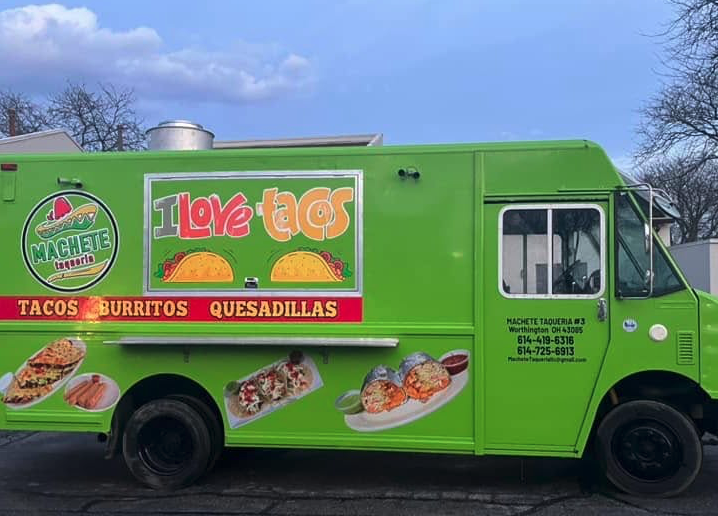 Thrive Companies, Bright green food truck with I Love Tacos and images of tacos, burritos, and quesadillas on the side, parked outdoors. Contact information is displayed near the drivers door. Apartments in Columbus Ohio